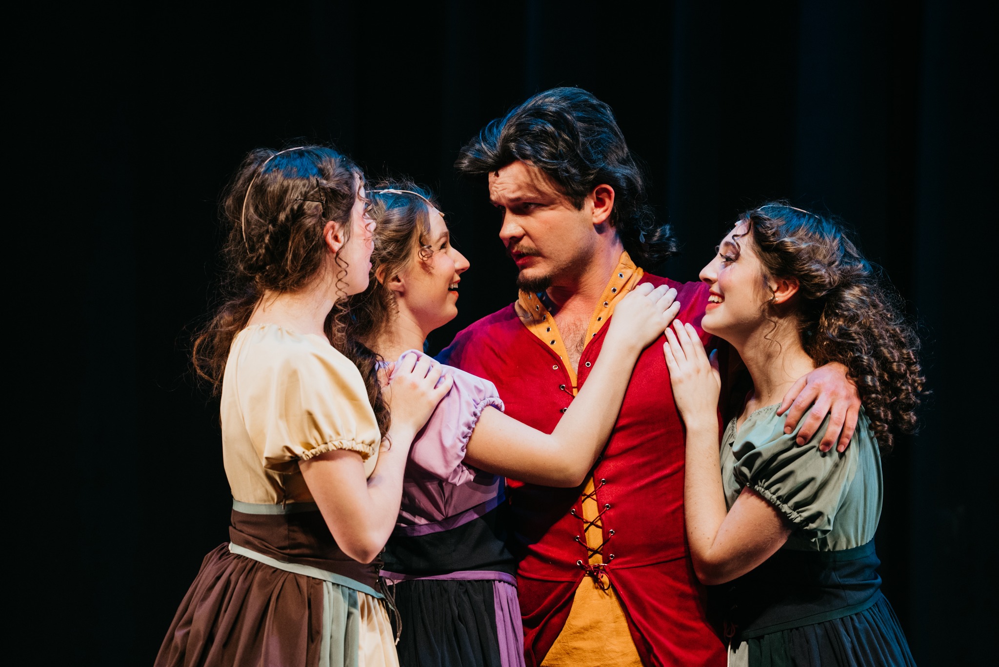 Gaston flanked by admirers