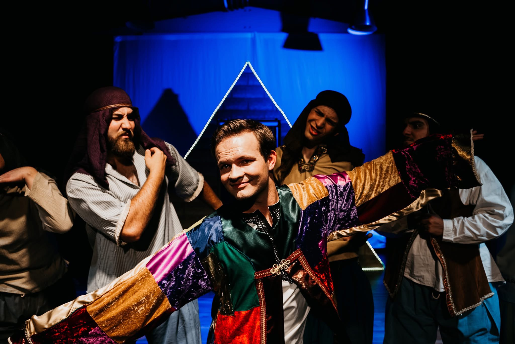 Ensemble in patchwork costume under blue wash